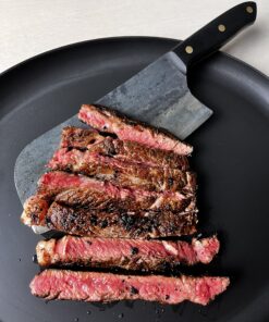 New york steak cooked rare on a cast iron skillet