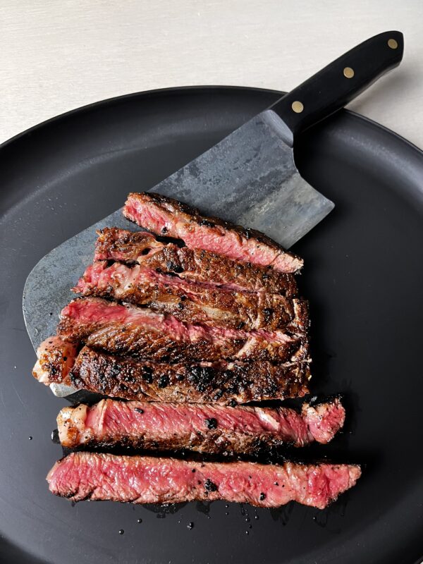 New york steak cooked rare on a cast iron skillet